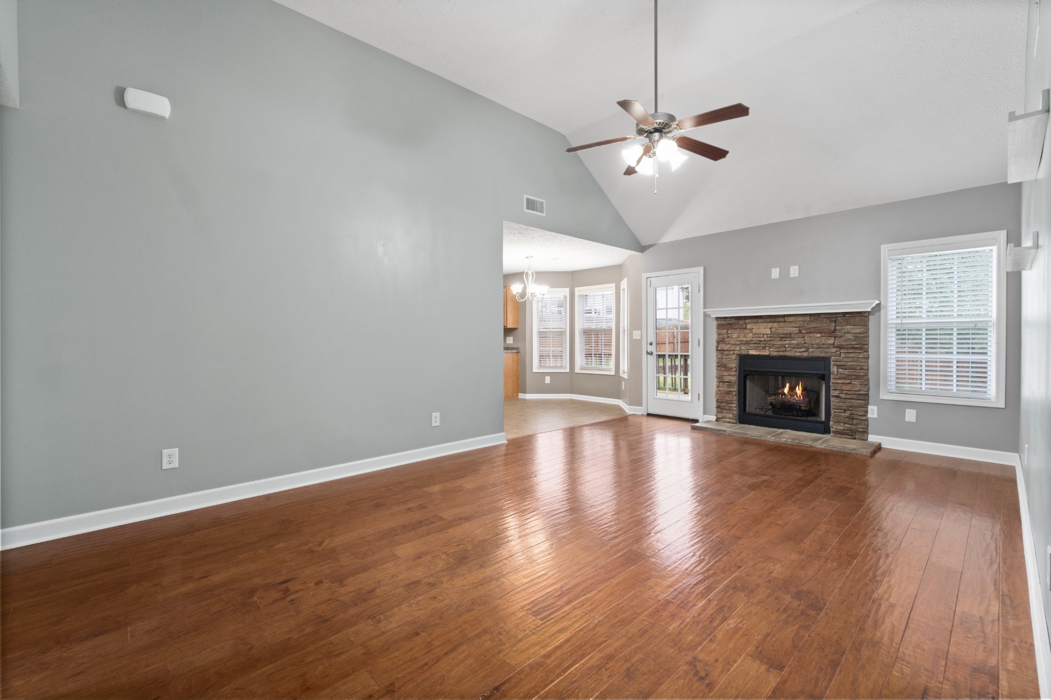 3178 Cross Ridge Drive Clarksville, TN 37040 - Photo 5 of 25 an empty room with wooden floor fireplace and windows