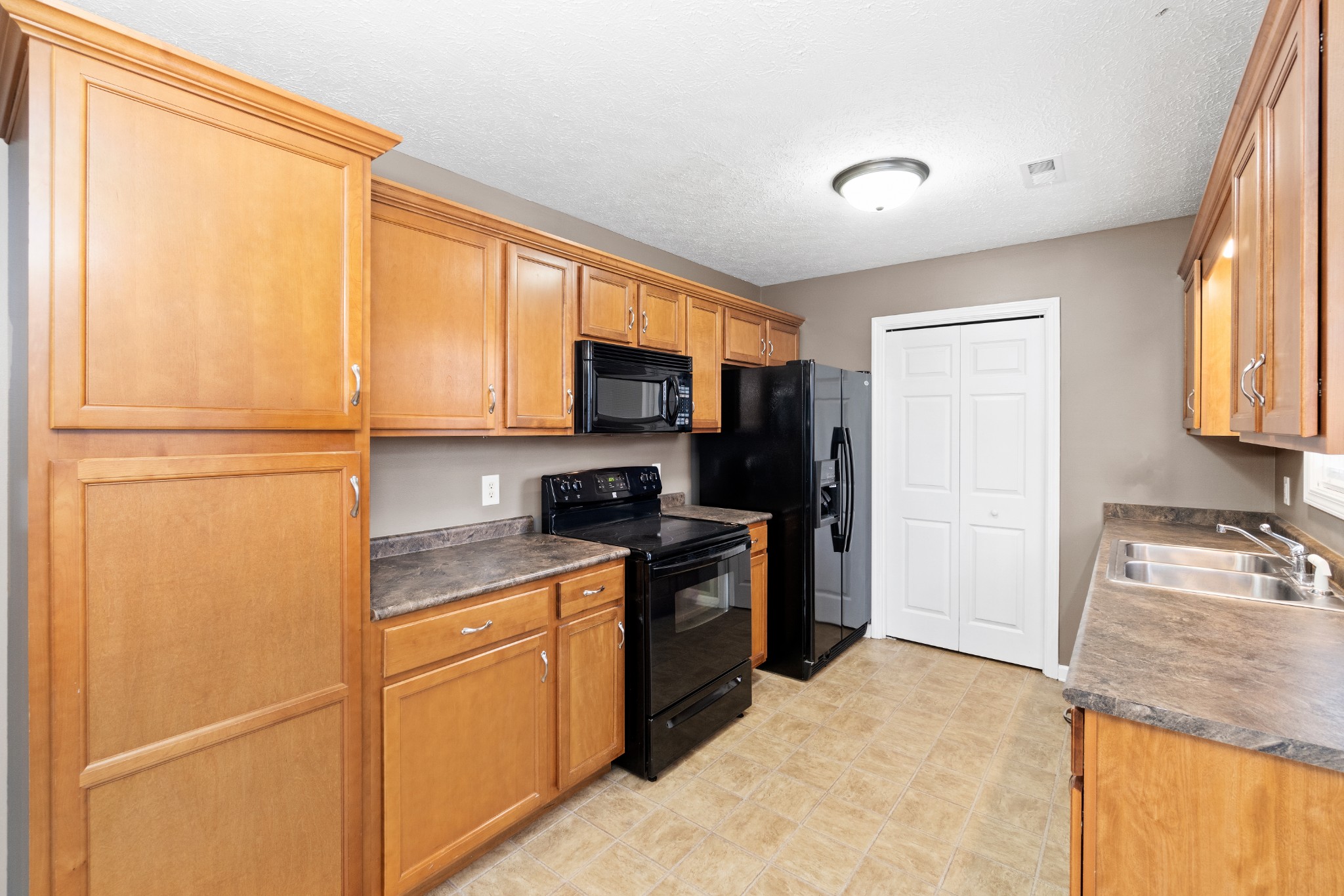 3178 Cross Ridge Drive Clarksville, TN 37040 - Photo 9 of 25 a kitchen with a refrigerator stove top oven and sink