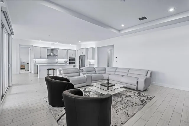 a dining room with furniture and view of kitchen
