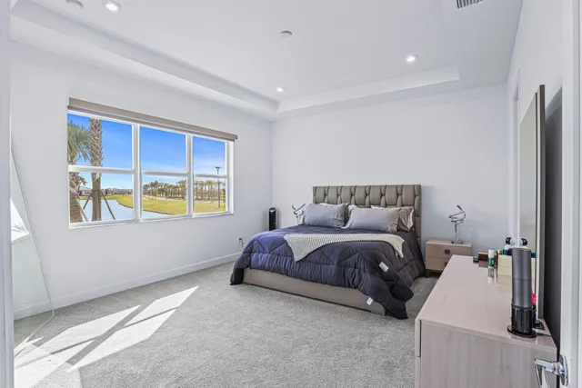 a spacious bedroom with a bed and a window