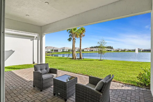 a view of a patio with a table & chairs