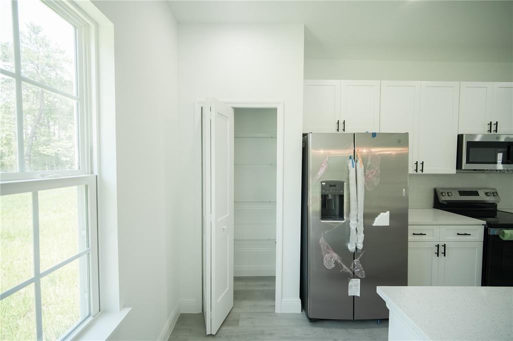 13265 Southwest 85th Circle Ocala, FL 34473 - Photo 16 of 53 a kitchen with stainless steel appliances granite countertop a refrigerator and a stove