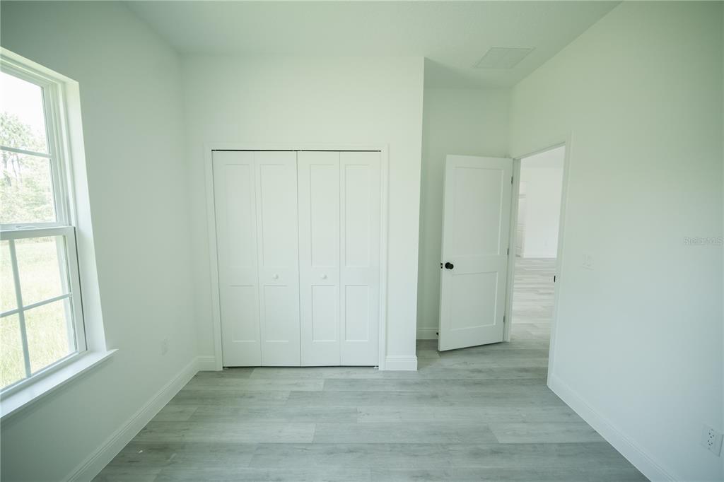 13265 Southwest 85th Circle Ocala, FL 34473 - Photo 22 of 53 an empty room with windows