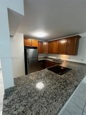 a kitchen with a refrigerator and a sink
