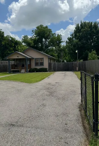 a backyard of a house with lots of green space and plants