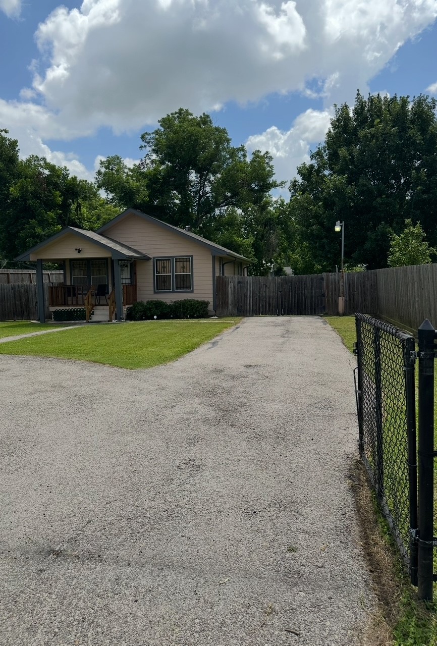 a backyard of a house with lots of green space and plants