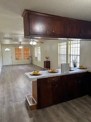 a room with a sink cabinets and window