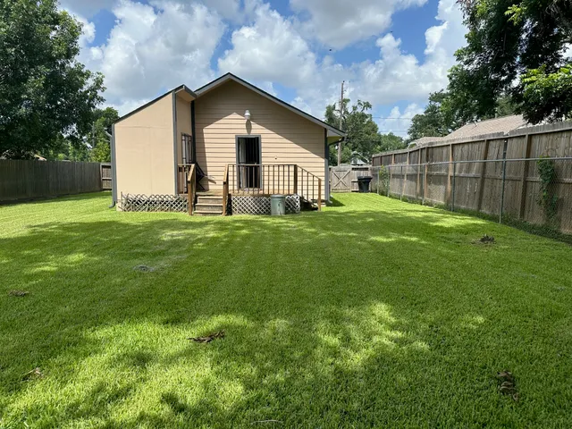 a view of a backyard with a garden and entertaining space