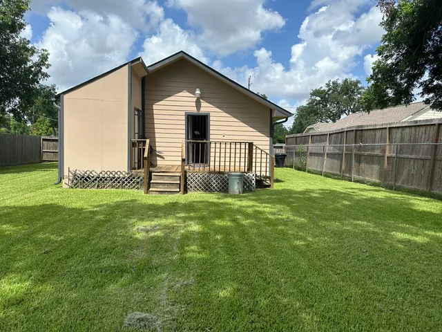a front view of a house with a garden and yard