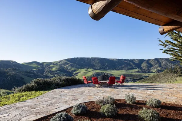 a view of swimming pool with a yard and mountain view