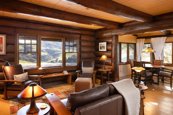 a living room with furniture and floor to ceiling windows