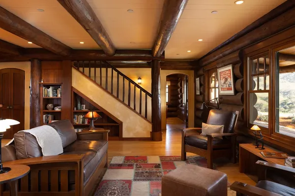 a living room with furniture fireplace and a large window
