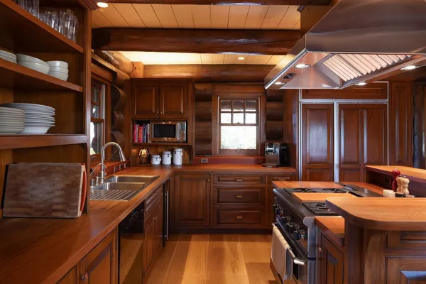 a kitchen with stainless steel appliances granite countertop a sink stove and cabinets