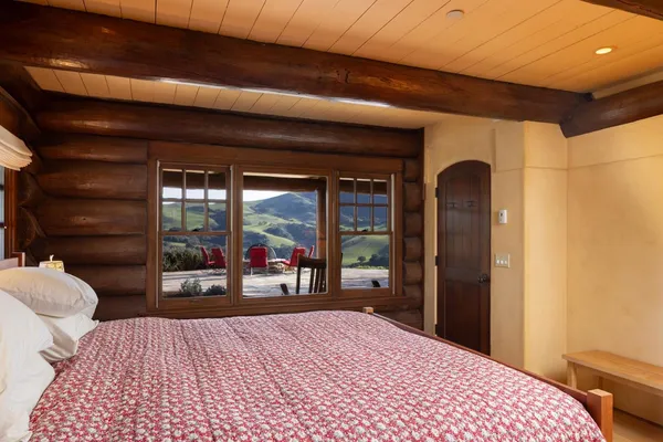 a bedroom with a bed and a large window