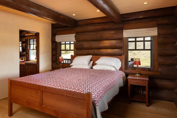 a bed sitting in a bedroom next to a window