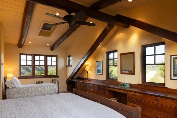 a living room with large windows and furniture