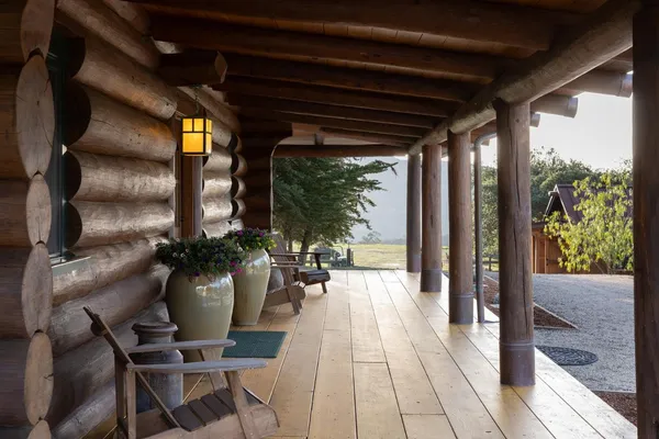 a view of a porch with chairs and couches with wooden floor