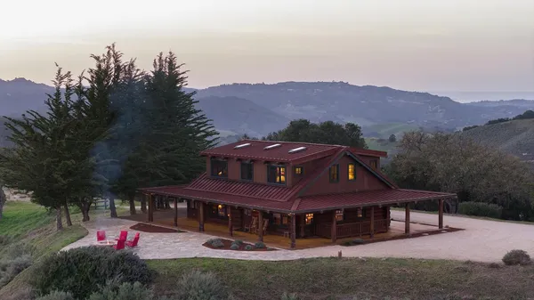 an aerial view of a house with a yard