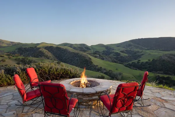 a view of a chairs and table in patio