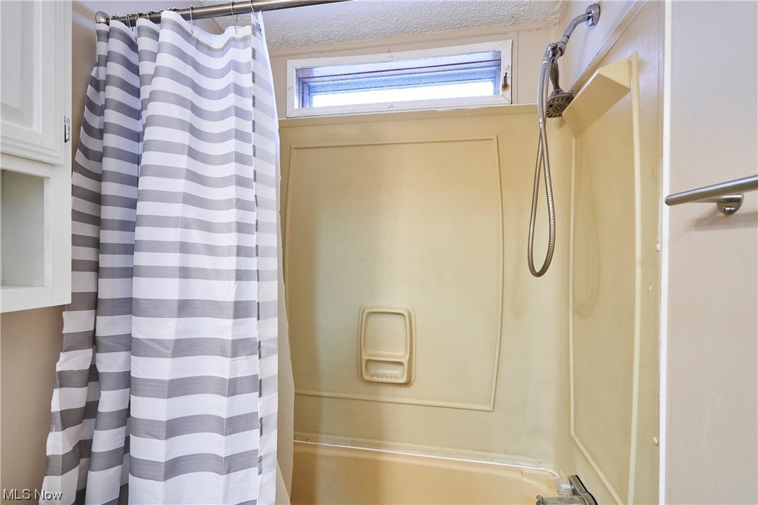 45 Eddie Road Madison, OH 44057 - Photo 20 of 26 Bathroom with shower / bathtub combination with curtain