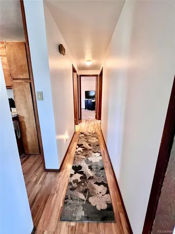 view of a hallway with wooden floor and stairs