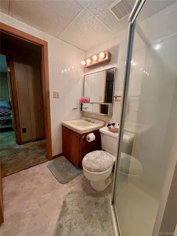 a bathroom with a sink toilet mirror and vanity