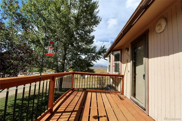 a view of balcony with wooden floor and fence