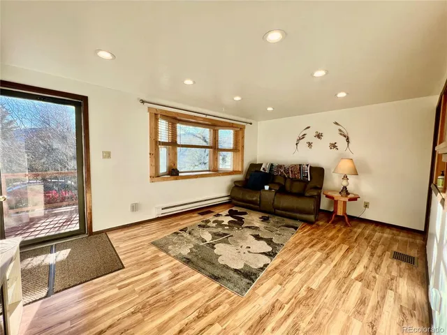 a living room with furniture and a rug
