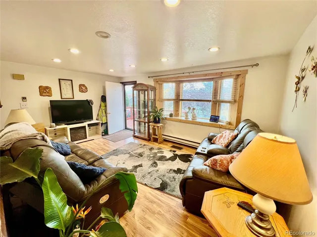 a living room with furniture fireplace and a flat screen tv