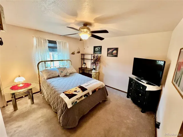 a bedroom with a bed and flat screen tv