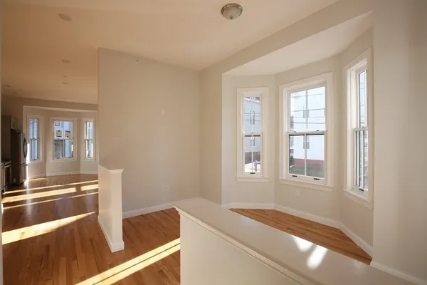 a view of a room that has a bed and a window