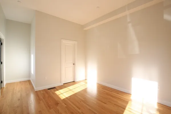 a view of an empty room and wooden floor
