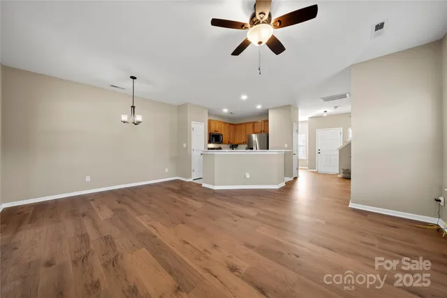 a view of a kitchen with a dishwasher cabinets and wooden floor