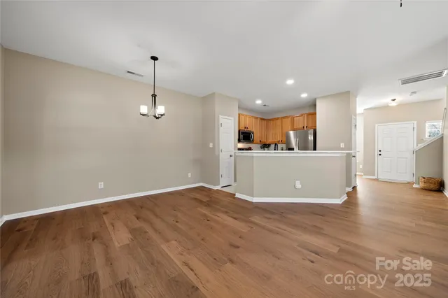 a view of a kitchen with a sink hardwood floor and a refrigerator