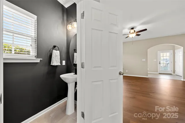 a view of a hallway with windows and chandelier