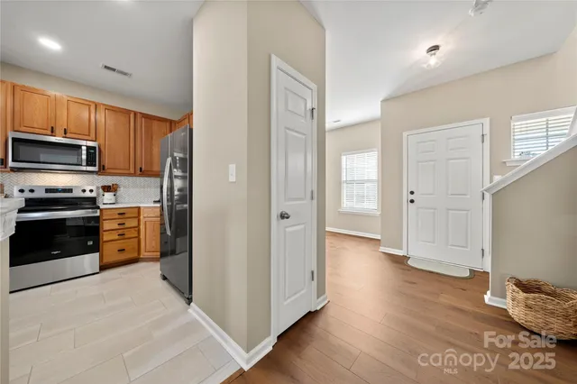 a kitchen with stainless steel appliances a refrigerator and a stove top oven