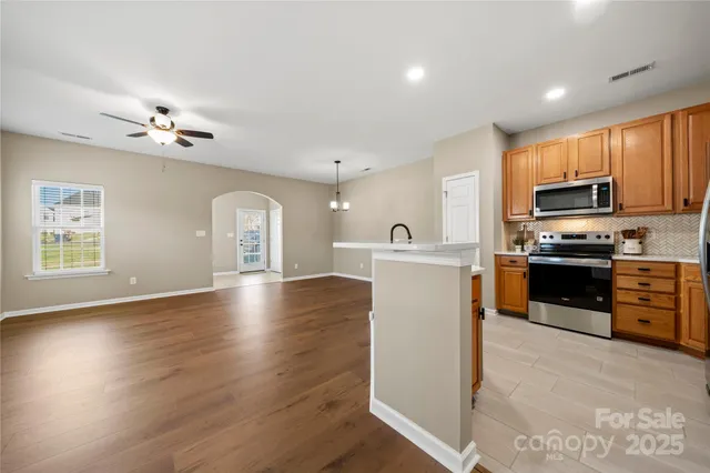 a view of kitchen with sink microwave and stove