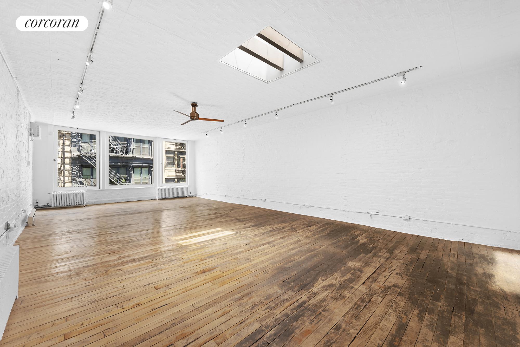 150 Spring Street, Unit PH Manhattan, NY 10012 - Photo 1 of 1 an empty room with wooden floor and windows
