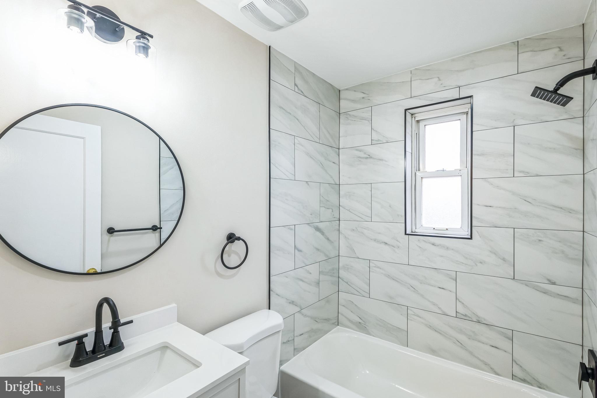 11901 Dalewood Drive Silver Spring, MD 20902 - Photo 12 of 17 a bathroom with a sink mirror toilet and shower