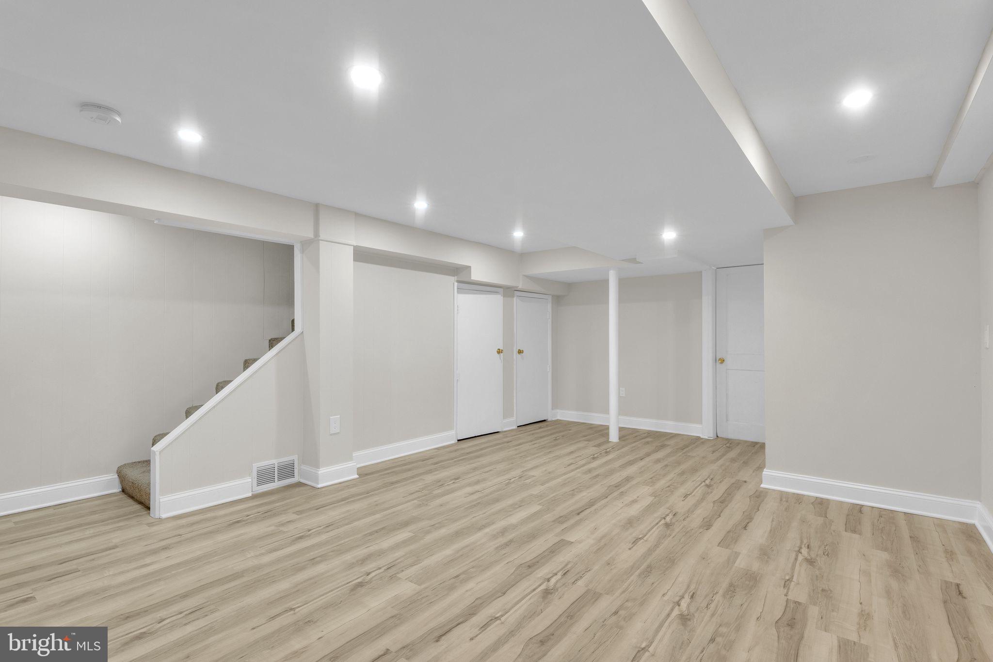 11901 Dalewood Drive Silver Spring, MD 20902 - Photo 14 of 17 an empty room with wooden floor and windows