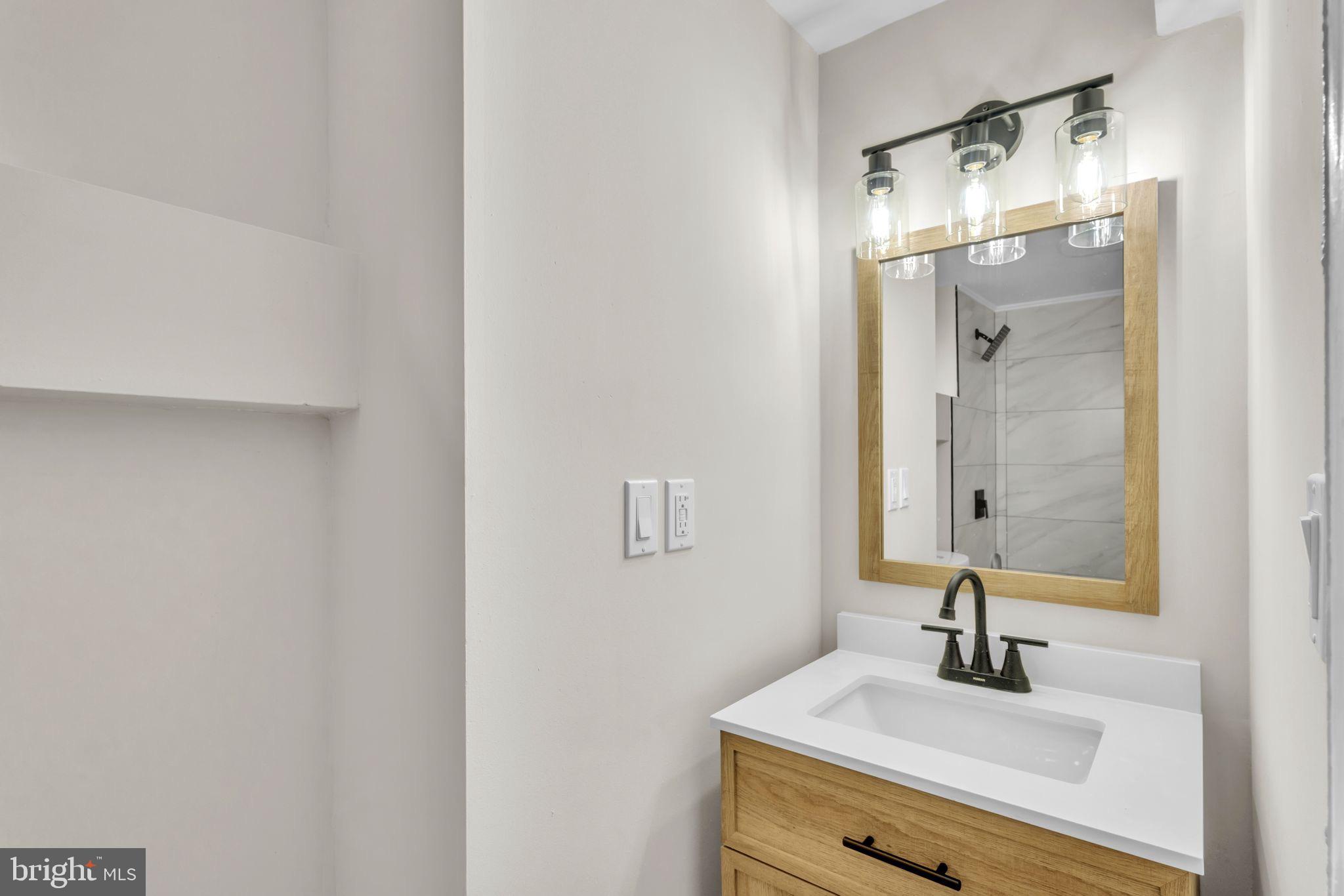 11901 Dalewood Drive Silver Spring, MD 20902 - Photo 16 of 17 a bathroom with a sink and a mirror