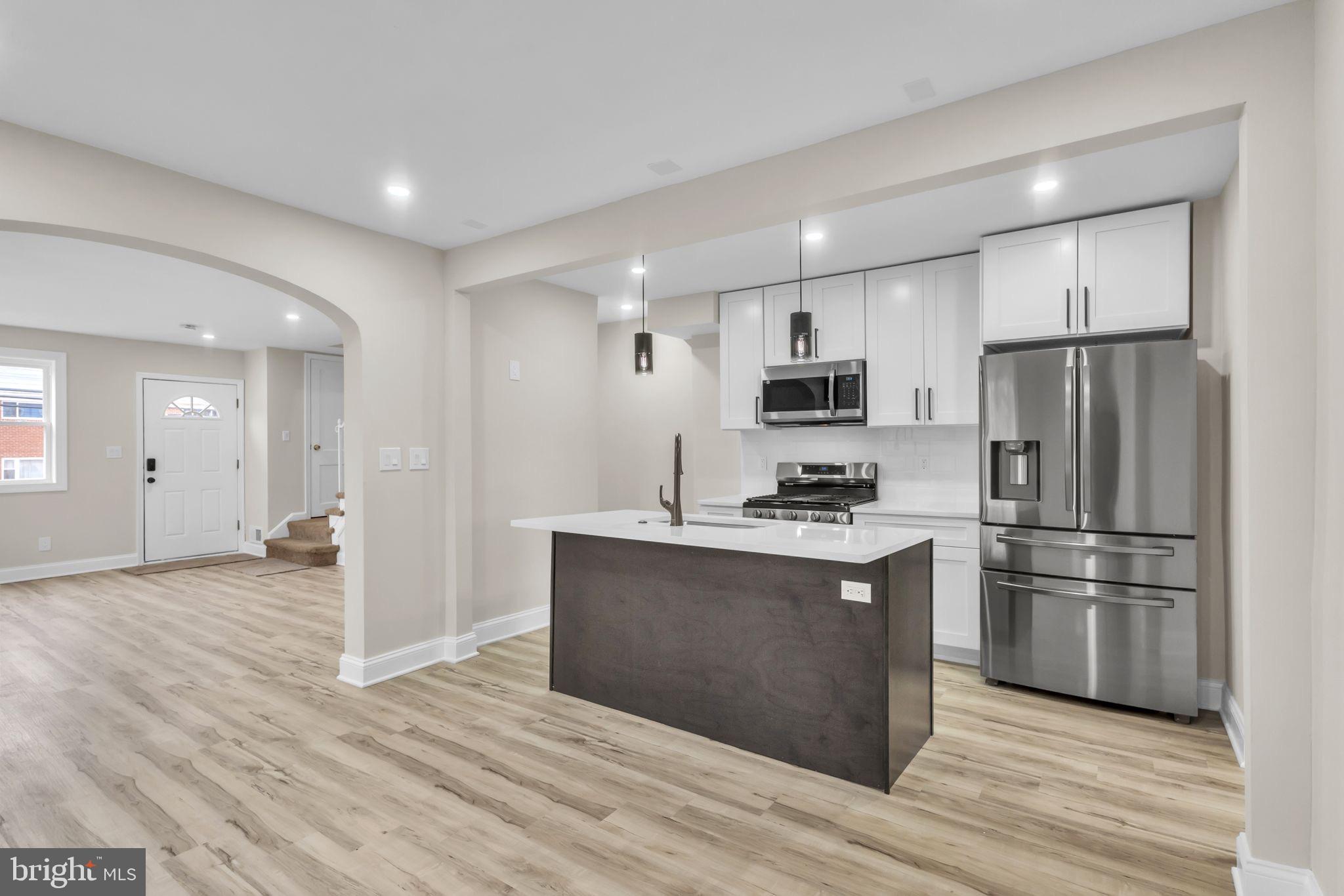 11901 Dalewood Drive Silver Spring, MD 20902 - Photo 4 of 17 a kitchen with stainless steel appliances granite countertop a refrigerator stove and white cabinets