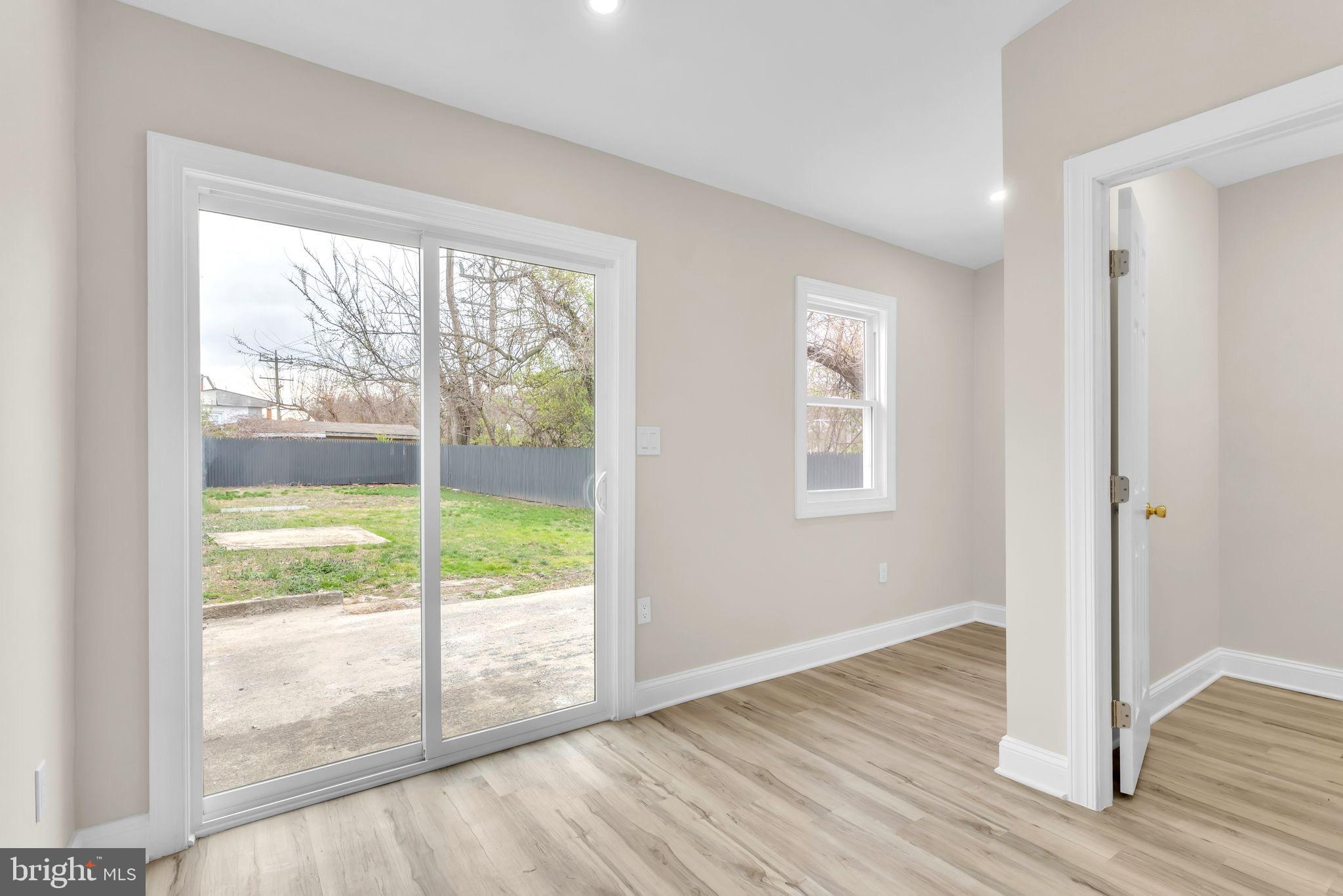 11901 Dalewood Drive Silver Spring, MD 20902 - Photo 6 of 17 a view of an empty room with wooden floor and windows