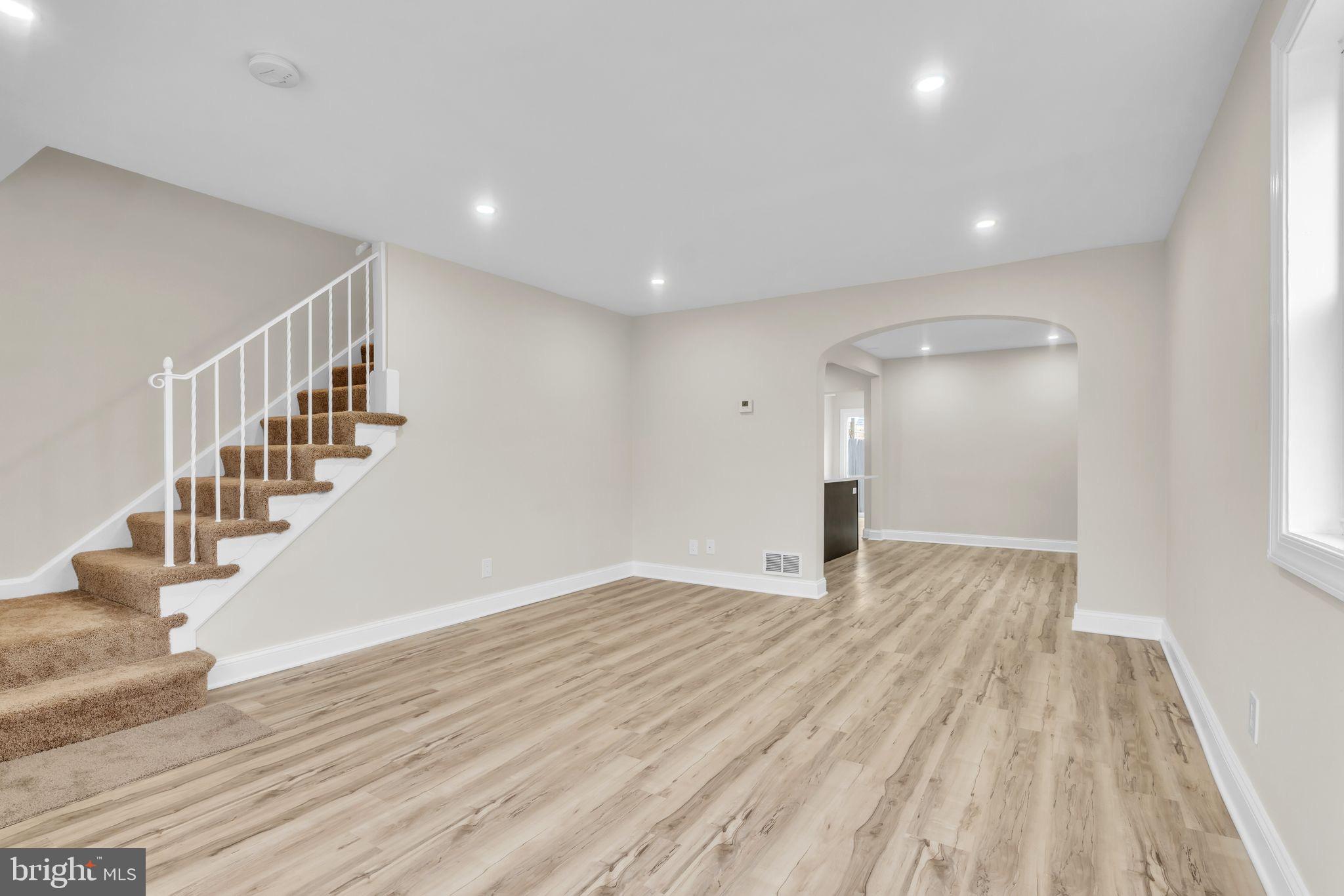 11901 Dalewood Drive Silver Spring, MD 20902 - Photo 7 of 17 a view of an empty room with wooden floor and entryway