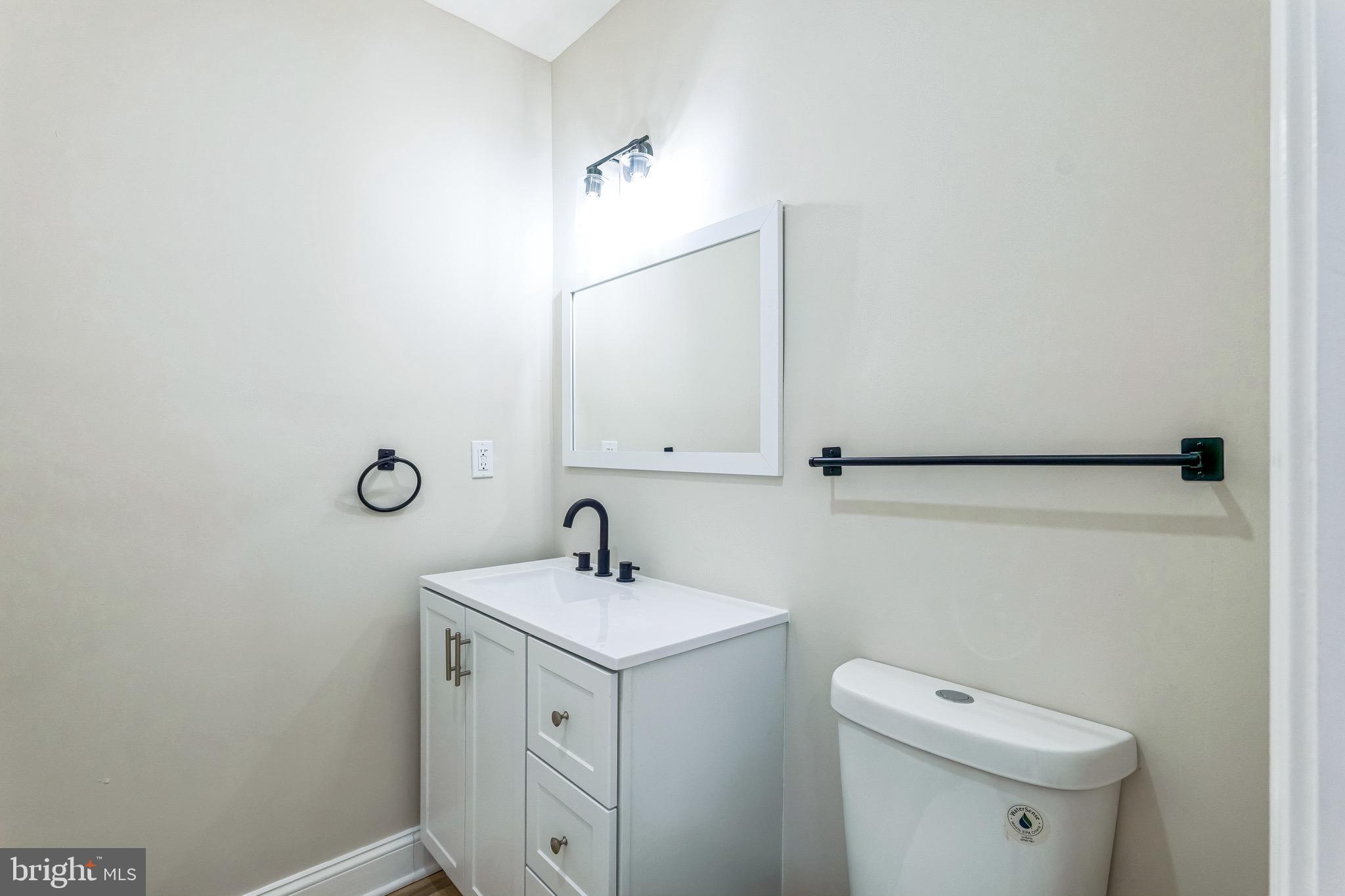 11901 Dalewood Drive Silver Spring, MD 20902 - Photo 8 of 17 a bathroom with a toilet sink and mirror