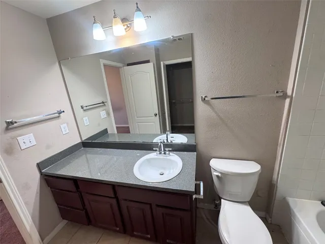 a bathroom with a sink toilet and mirror