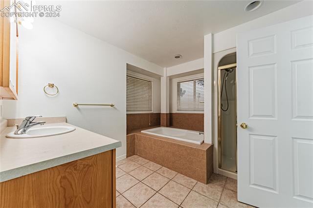1027 County Road LL Fowler, CO 81039 - Photo 22 of 37 Bathroom featuring tile patterned floors, vanity, and shower with separate bathtub