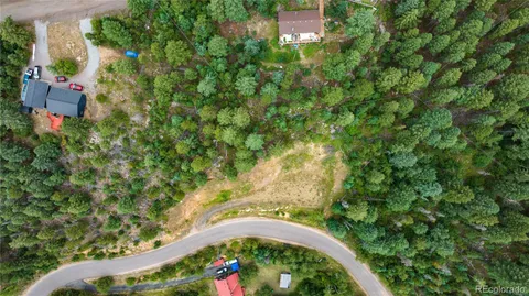 an aerial view of a house with a yard and lake view