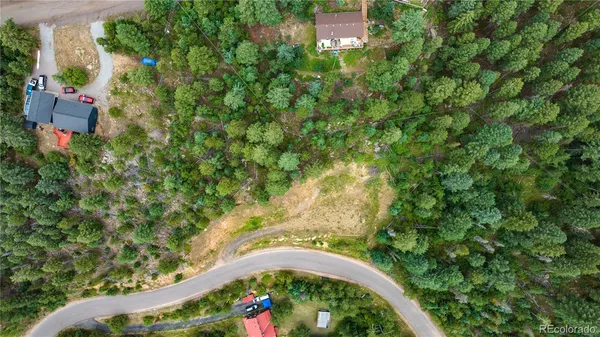 an aerial view of a house with a yard and lake view