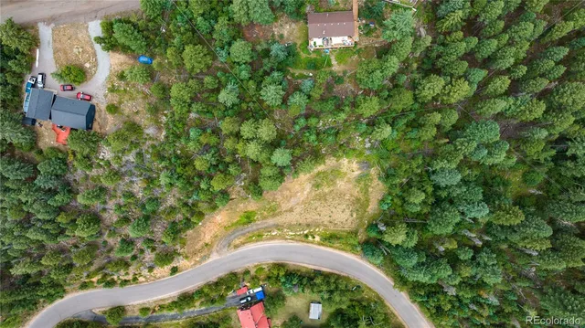 an aerial view of a house with a yard and lake view